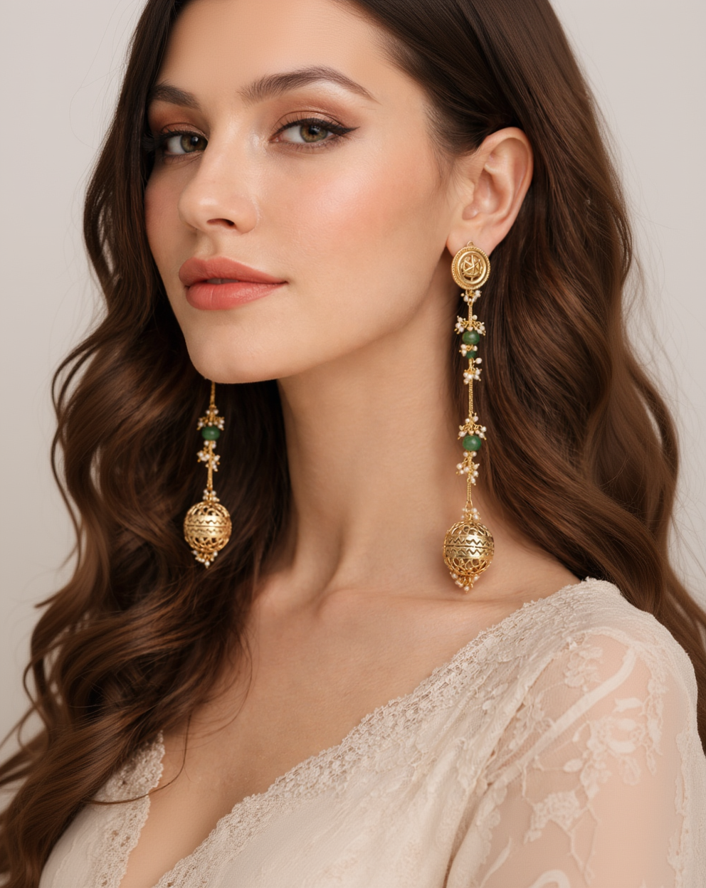 Ornate Gold Jhumka Earrings with Green Emerald Drops and Pearl Accents-G352400